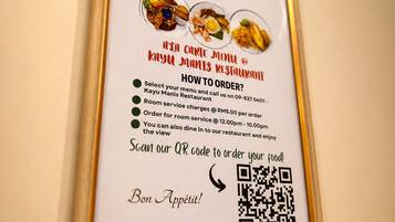 A framed menu with QR code for ordering at KAYU MANIS RESTAURANT.