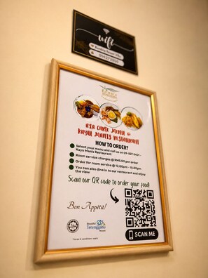 A framed menu with QR code for ordering at KAYU MANIS RESTAURANT.