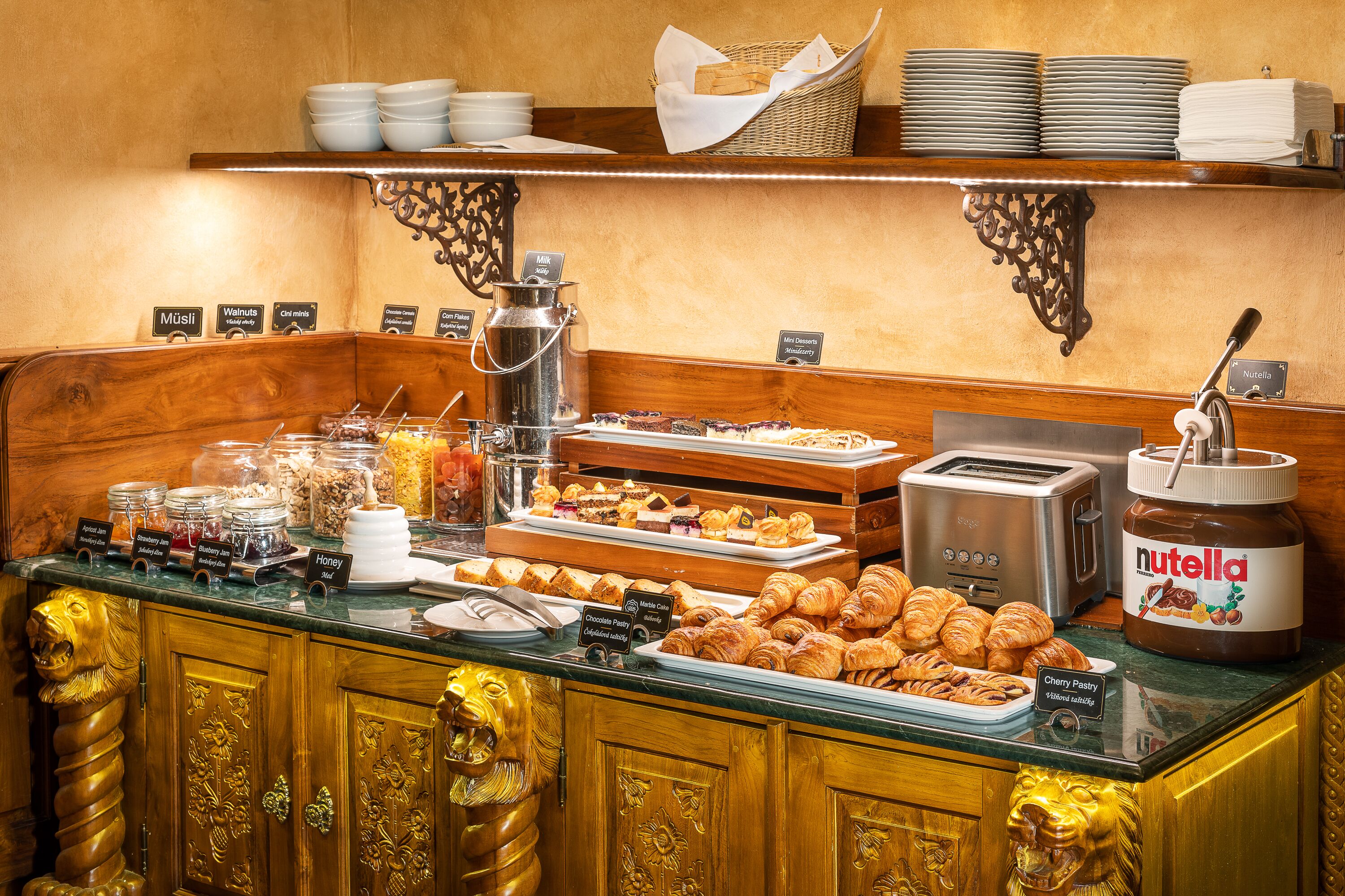 A breakfast buffet with various food items and a Nutella jar.