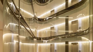 A multi-level interior with glass railings, marble floors, and modern lighting. - The One Barcelona GL (Barcelona)