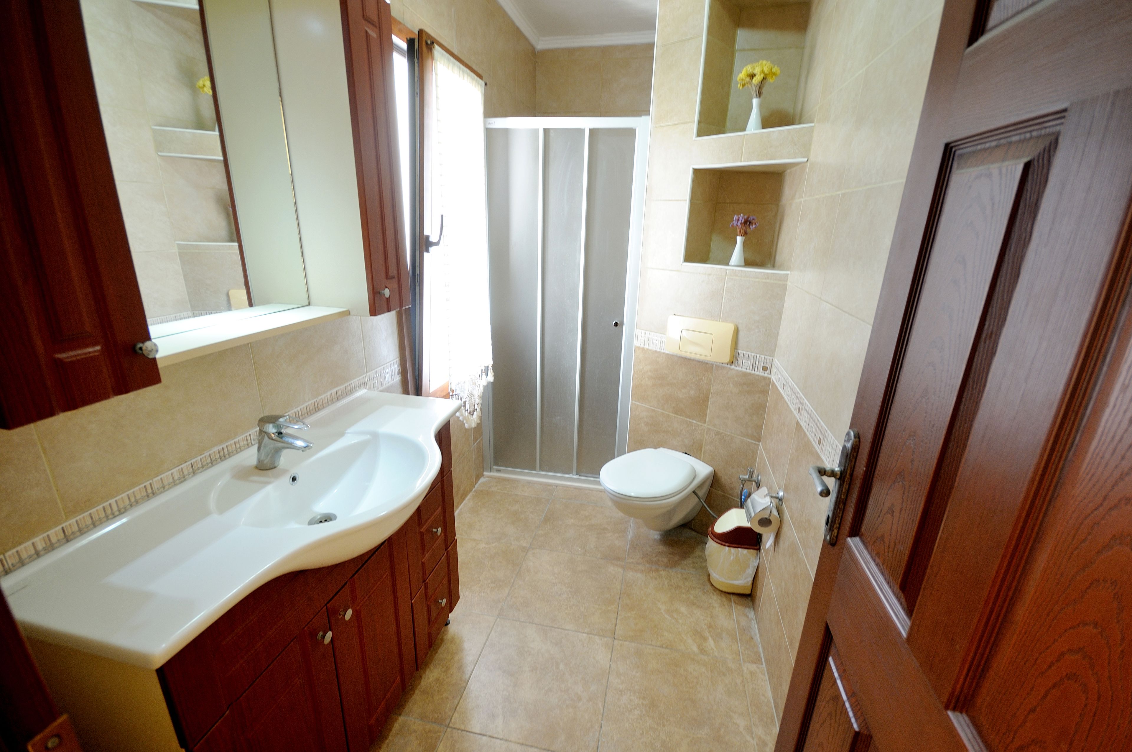 A bathroom with a sink, toilet, and shower.