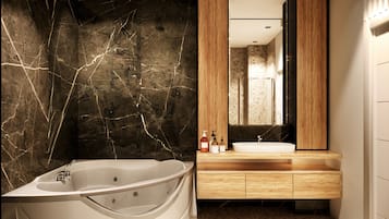 Un baño moderno con una bañera independiente, un tocador de madera y un espejo grande.