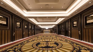 A long, ornate hallway with a patterned carpet and modern lighting. - Ramada by Wyndham Lucknow Hotel and Convention Center (Lucknow)
