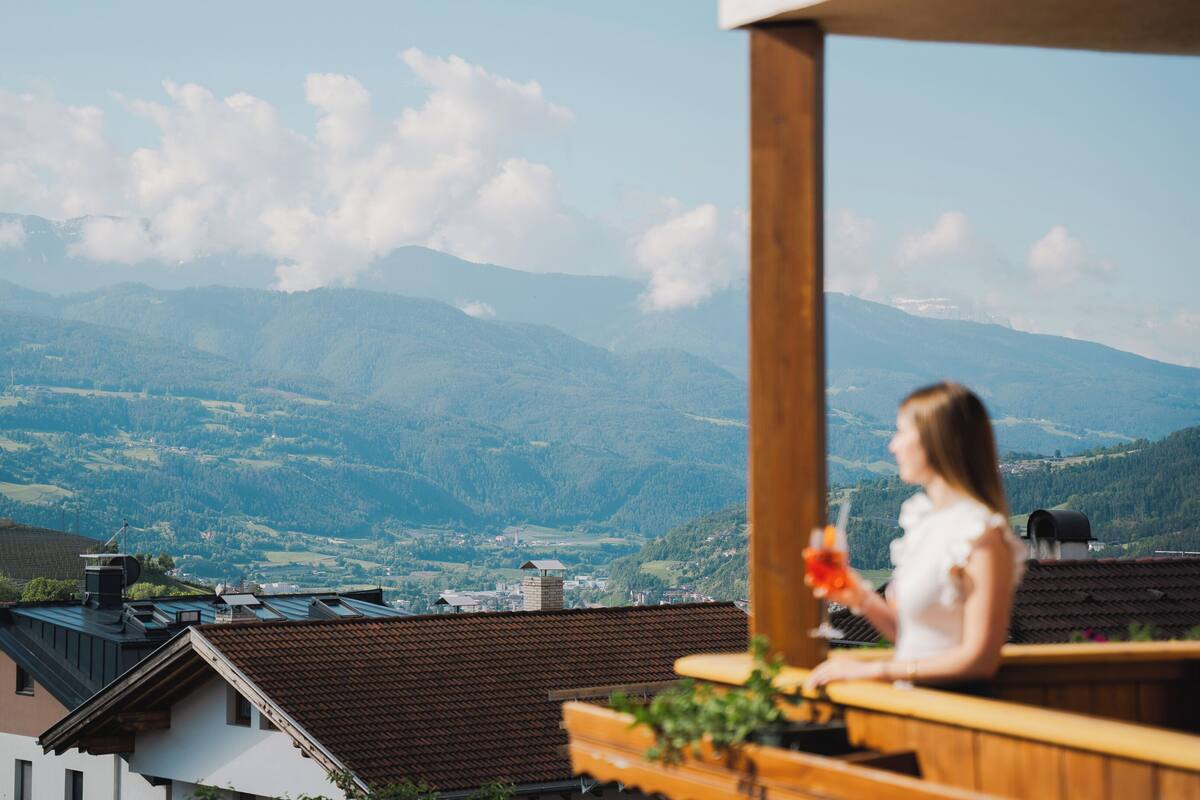 A balcony with a view of a mountainous landscape.