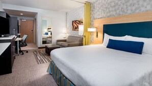 A hotel room with a bed, desk, chair, and a television. - Home2 Suites by Hilton Ft. Lauderdale Airport-Cruise Port (Dania Beach)