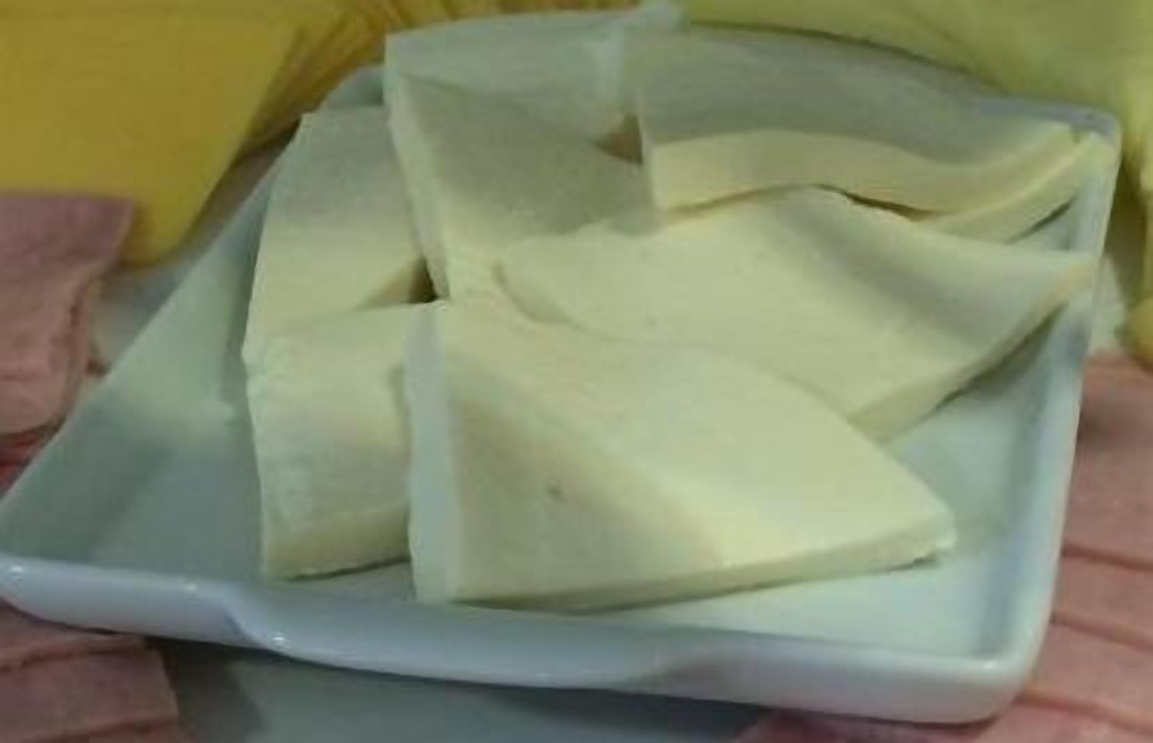 A white rectangular plate with several white triangular objects on it.