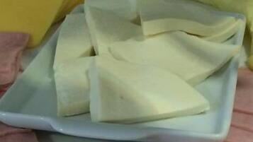 A white rectangular plate with several white triangular objects on it.