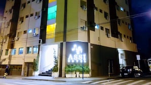 Un hôtel à plusieurs étages, dont l’enseigne « ASSI » est bien visible sur la façade.