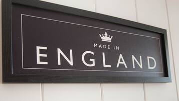 A sign with "ENGLAND" and "MADE IN ENGLAND" text, framed in dark wood.