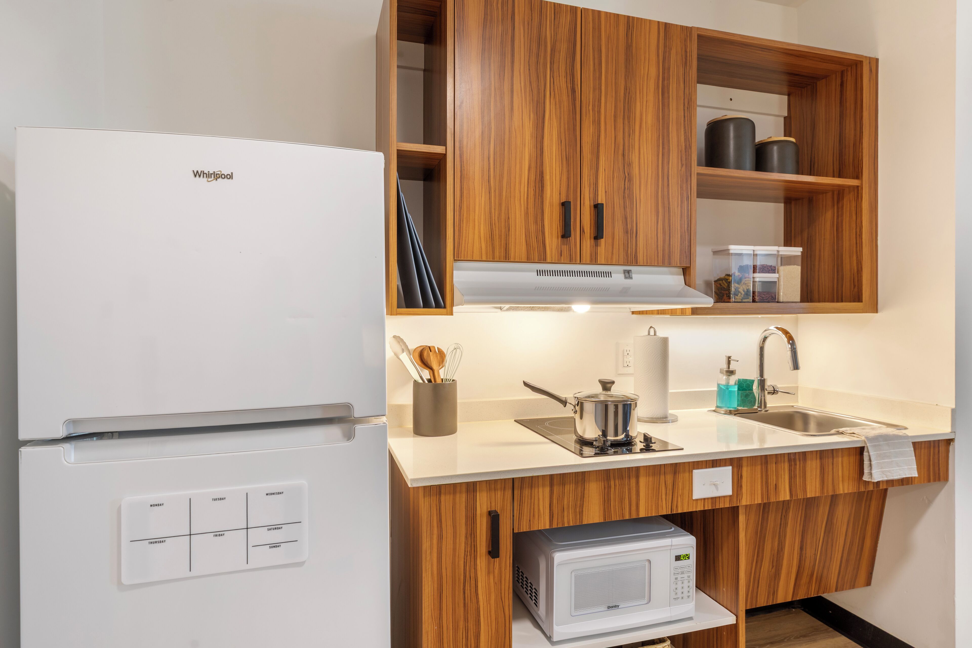 full-sized fridge, microwave, stovetop, coffee/tea maker