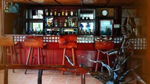 A bar area with wooden furniture and a tiled floor.