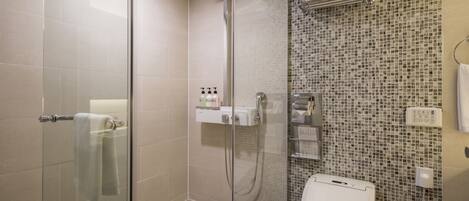 A modern bathroom with a glass shower enclosure, a toilet, and a sink.