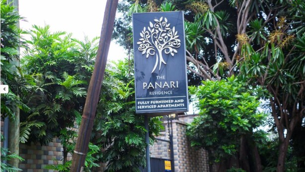 A sign for The Panari Residence, indicating it is a fully furnished and serviced apartment complex.