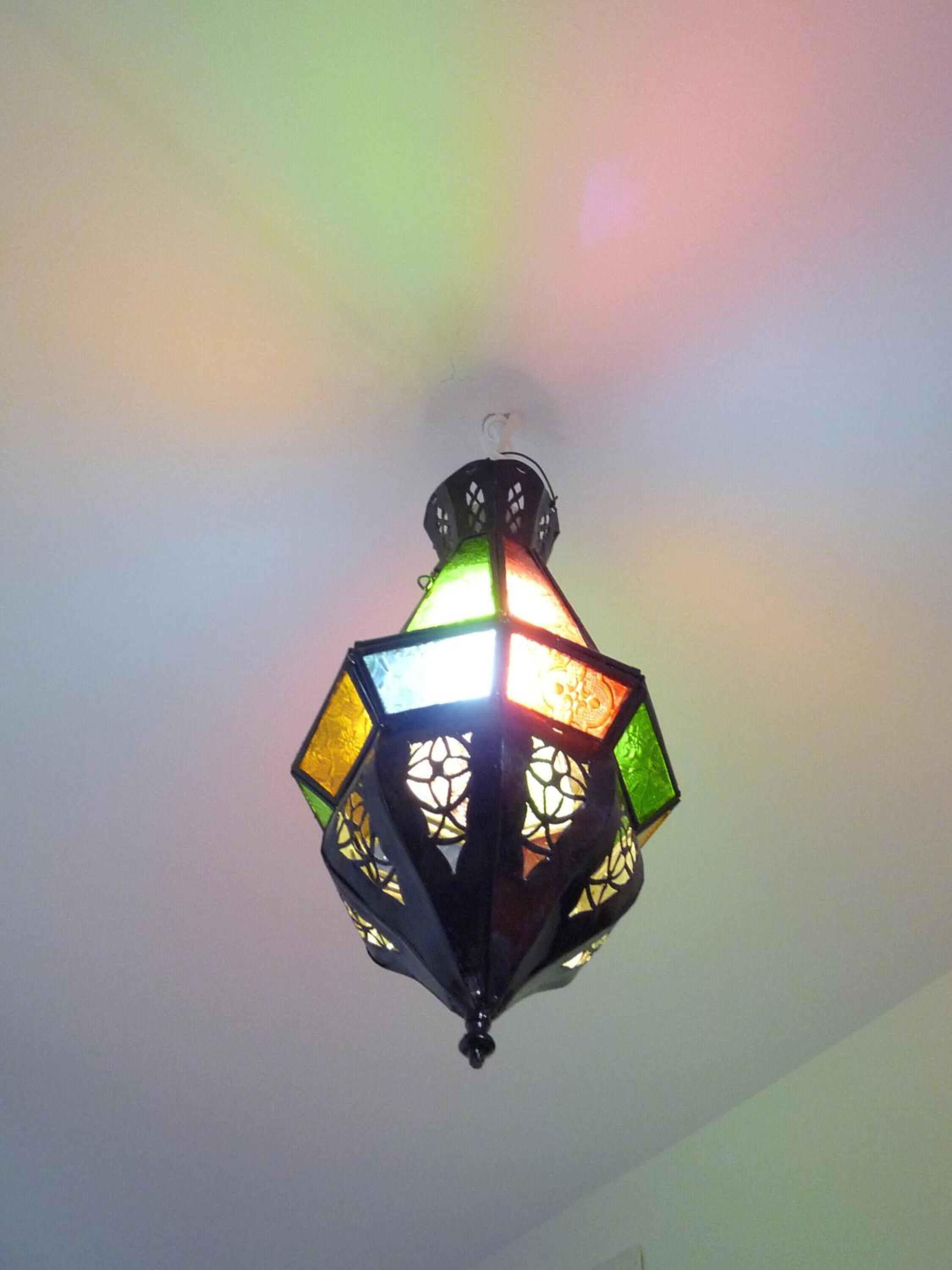 A multi-colored, geometric-patterned hanging light fixture.