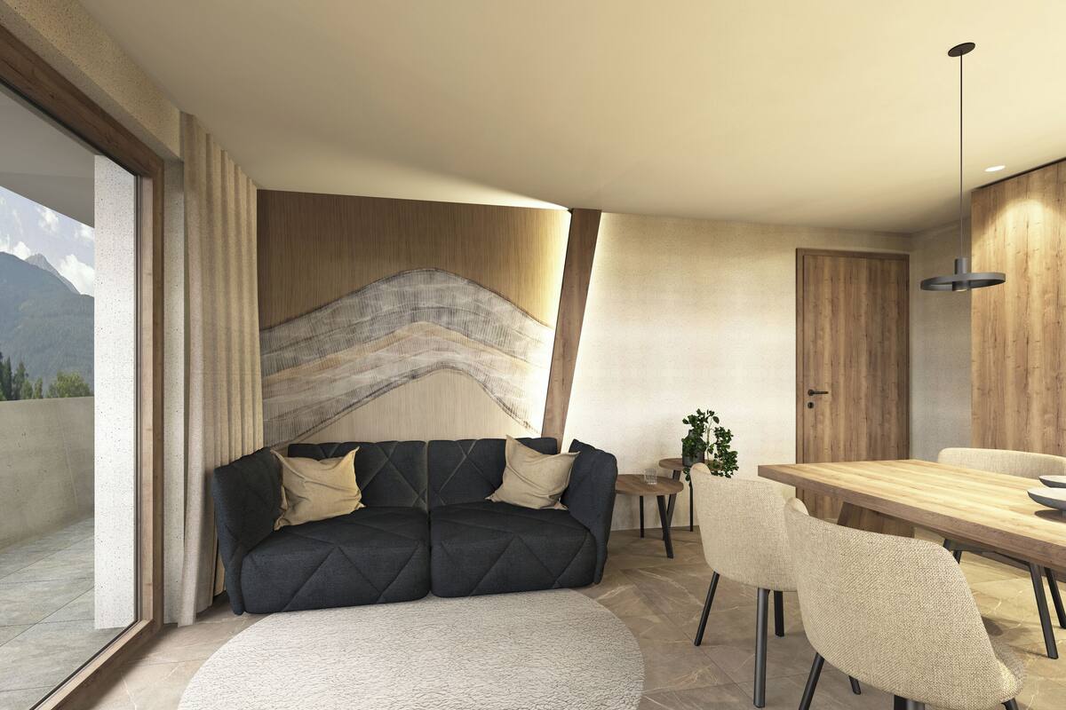 A modern living room with a sofa, a round rug, a dining table with chairs, and a view of mountains through a large window.