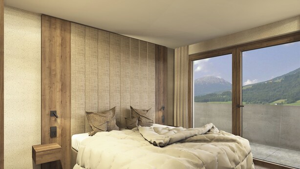 A bedroom with a large bed, a nightstand, a view of mountains through a sliding door. - Aparthotel Kronplatz Luxury House (Valdaora)