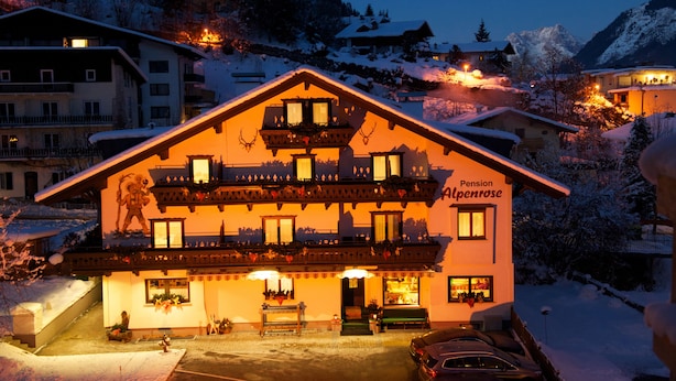 A two-story building with a balcony, labeled "Pension Alpenrose," surrounded by snow-covered trees and buildings. - Pension Alpenrose (Zell am See)