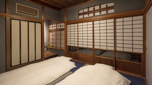 A traditional Japanese room with tatami flooring, a shoji screen, and a futon bed.