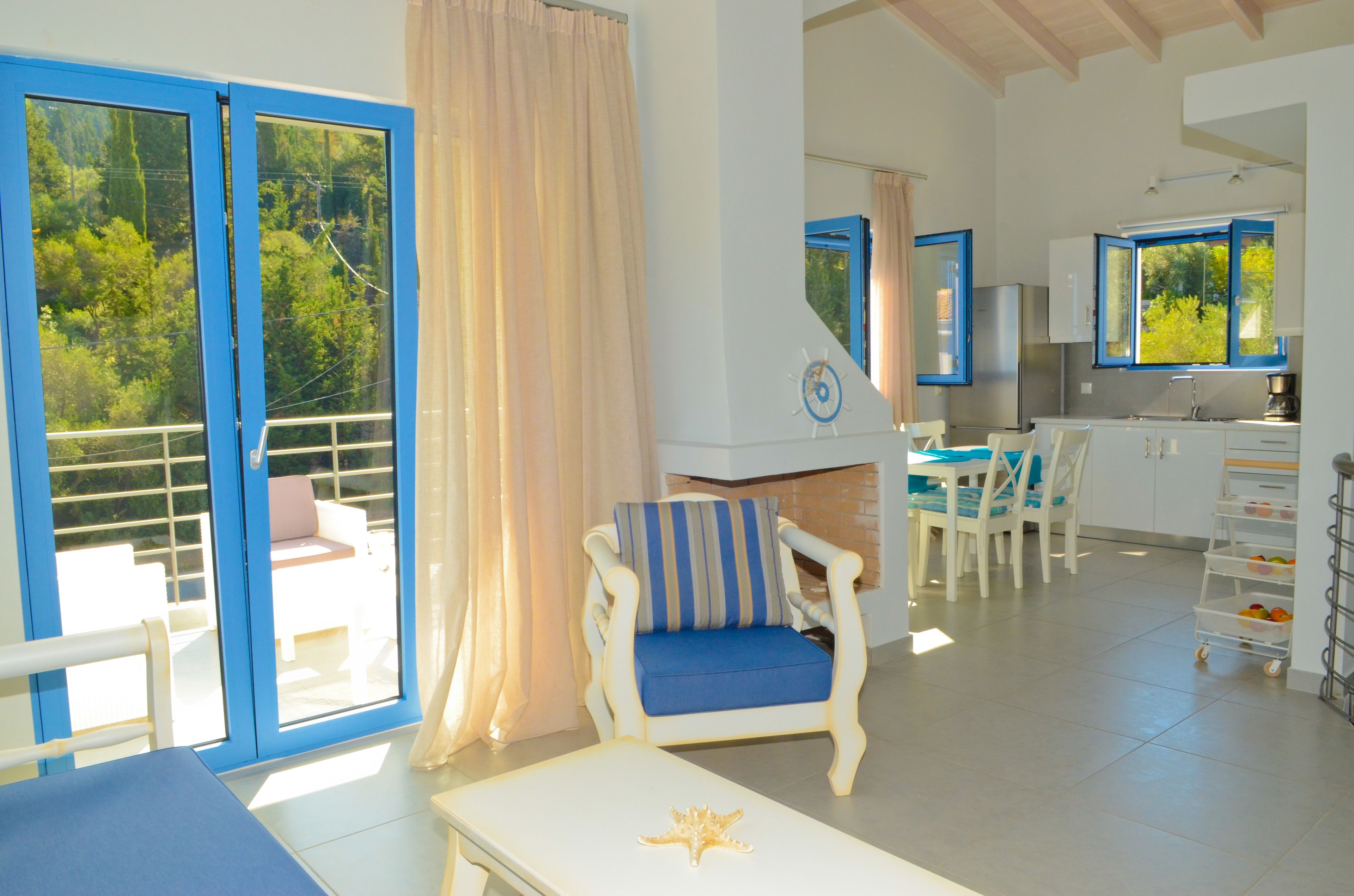 A spacious living area with a balcony, a dining area, and a kitchen.