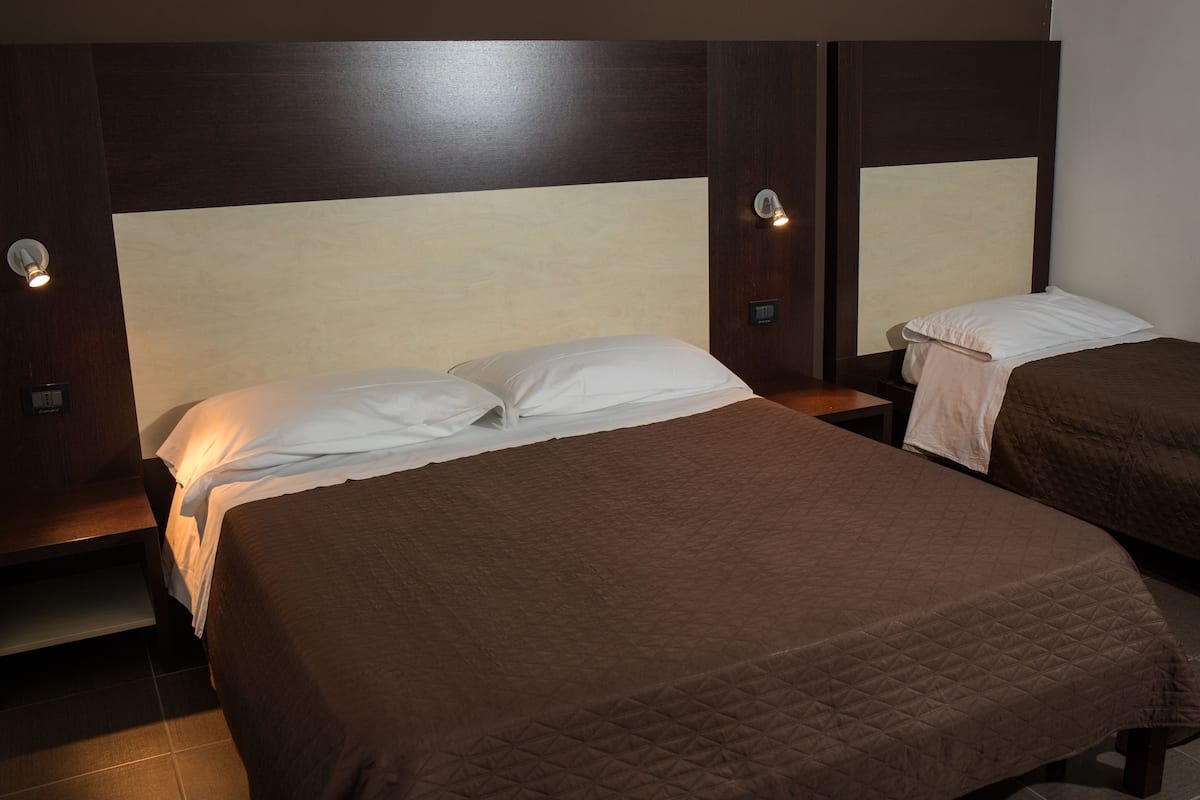 Quadruple Room | Pillow-top beds, minibar, in-room safe, desk