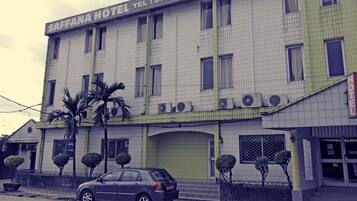 A building with a sign reading "SAFFANA HOTEL" and a car parked in front.