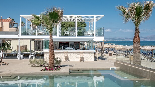 A resort with a pool, outdoor seating, and a beach view. - Sea Front Villas (Chania)