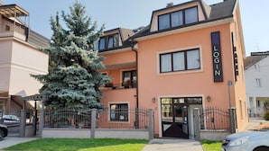 Un bâtiment à deux étages dont la façade porte une enseigne indiquant « SALLES D’ENREGISTREMENT ».