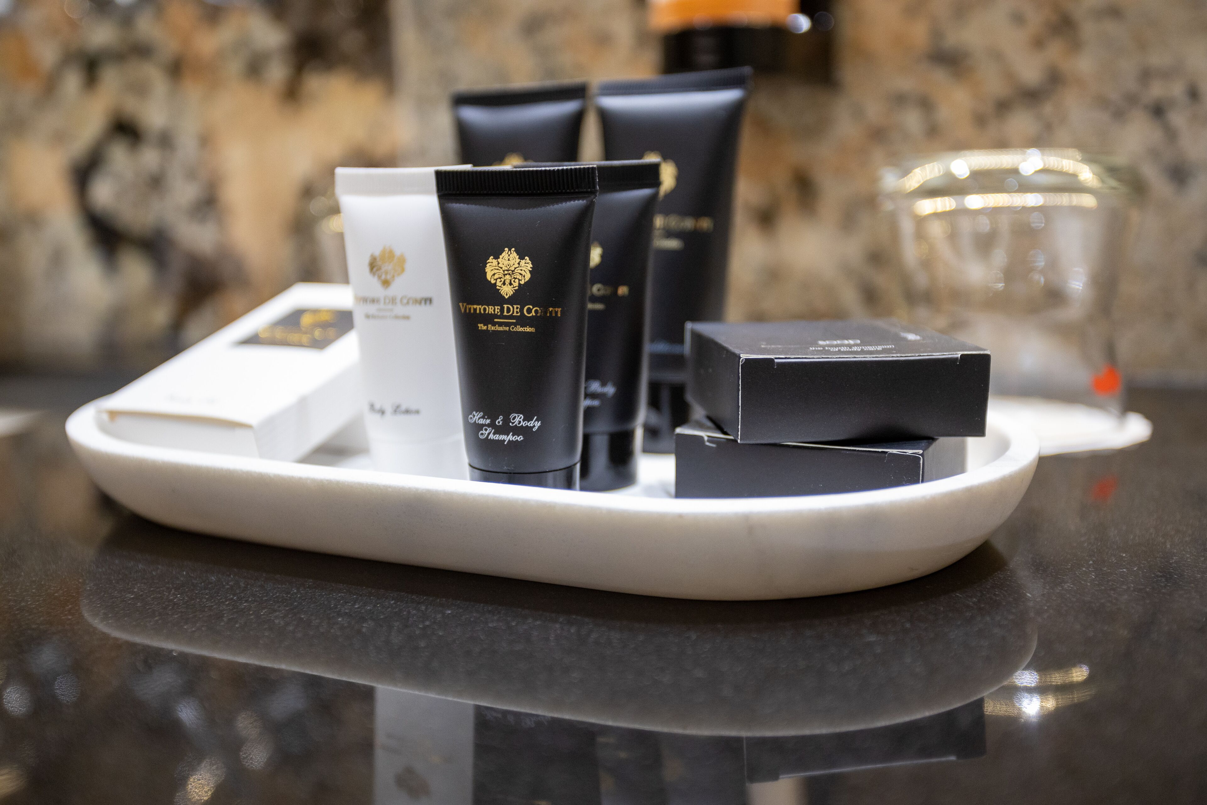 designer toiletries, hair dryer, towels, soap