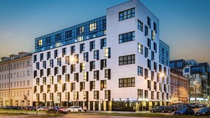 A modern hotel with a grid of windows, a flat roof, and a sign for 'Hotel Royal Prague'. - Hotel Royal Prague (Prague)
