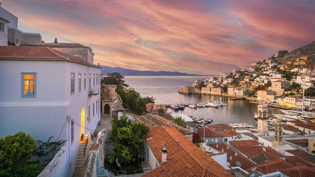 A coastal town with historic buildings, a marina, and a clear view of the sea. - Hydra Hotel (Hydra)