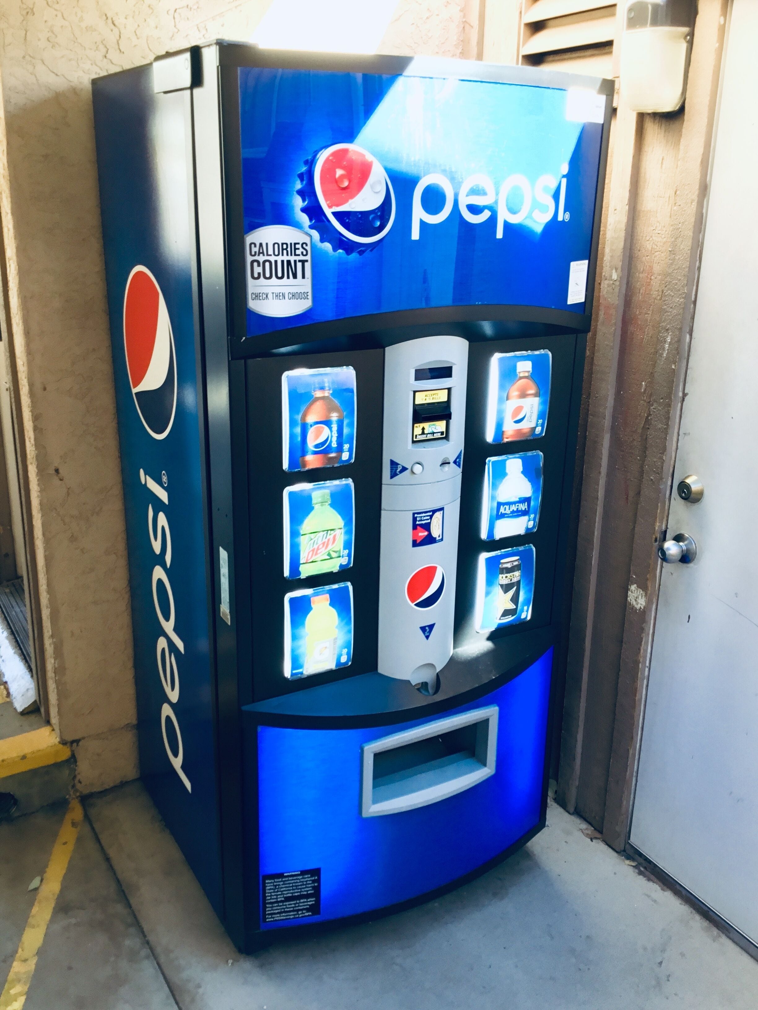 A Pepsi vending machine with a digital display and multiple beverage options.
