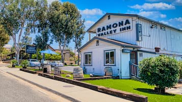Experience the charm of a historic building with a classic architectural style, featuring a prominent signboard and welcoming entrance.