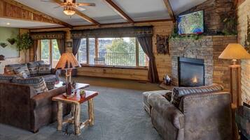 Treetop Penthouse Suite | Living room | Flat-screen TV, fireplace