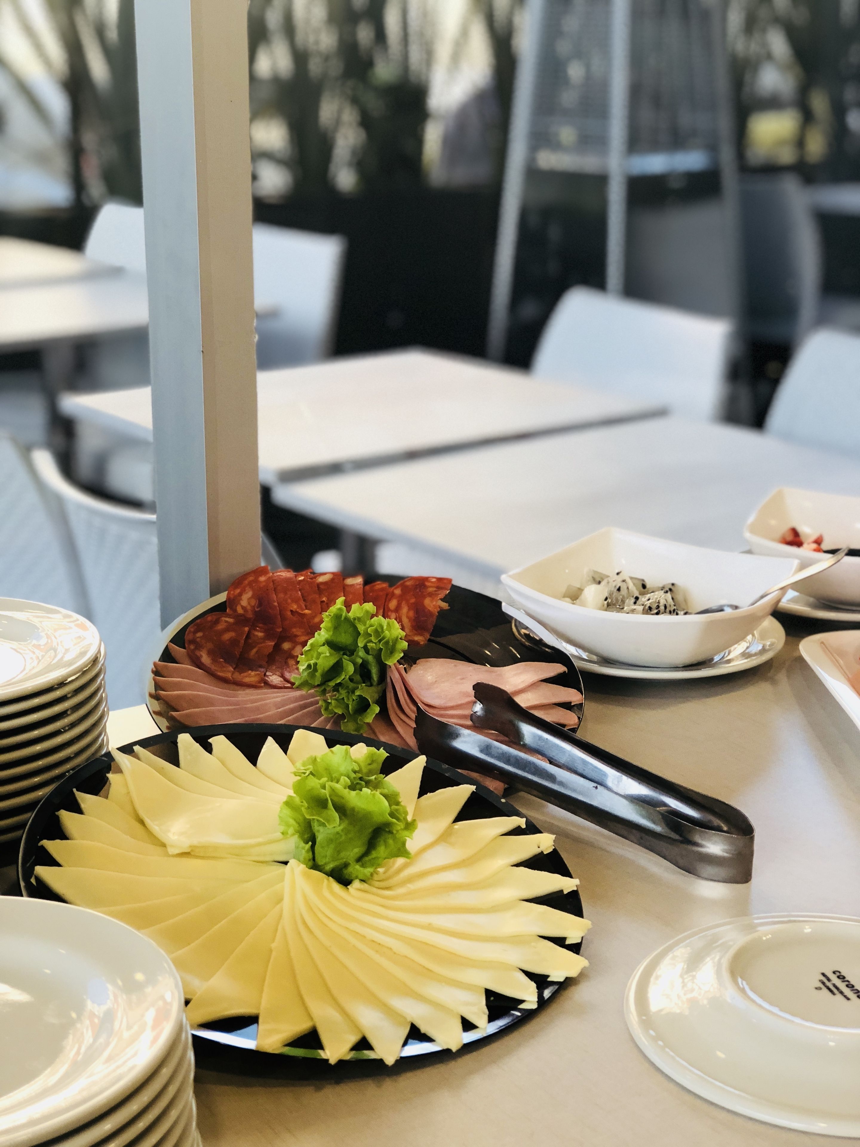 A table with a variety of food items, including sliced meats and cheese, arranged for a meal.
