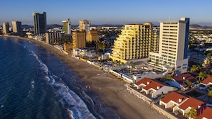 A coastal cityscape with high-rise buildings, a beach, and a clear sky. - Ocean View Beach Hotel (Mazatlán)