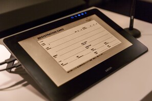 A registration card on a tablet with a USB cable connected. - Hotel Resol Nagoya (Nagoya)