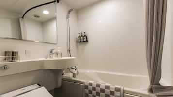 A modern bathroom with a toilet, sink, and bathtub.