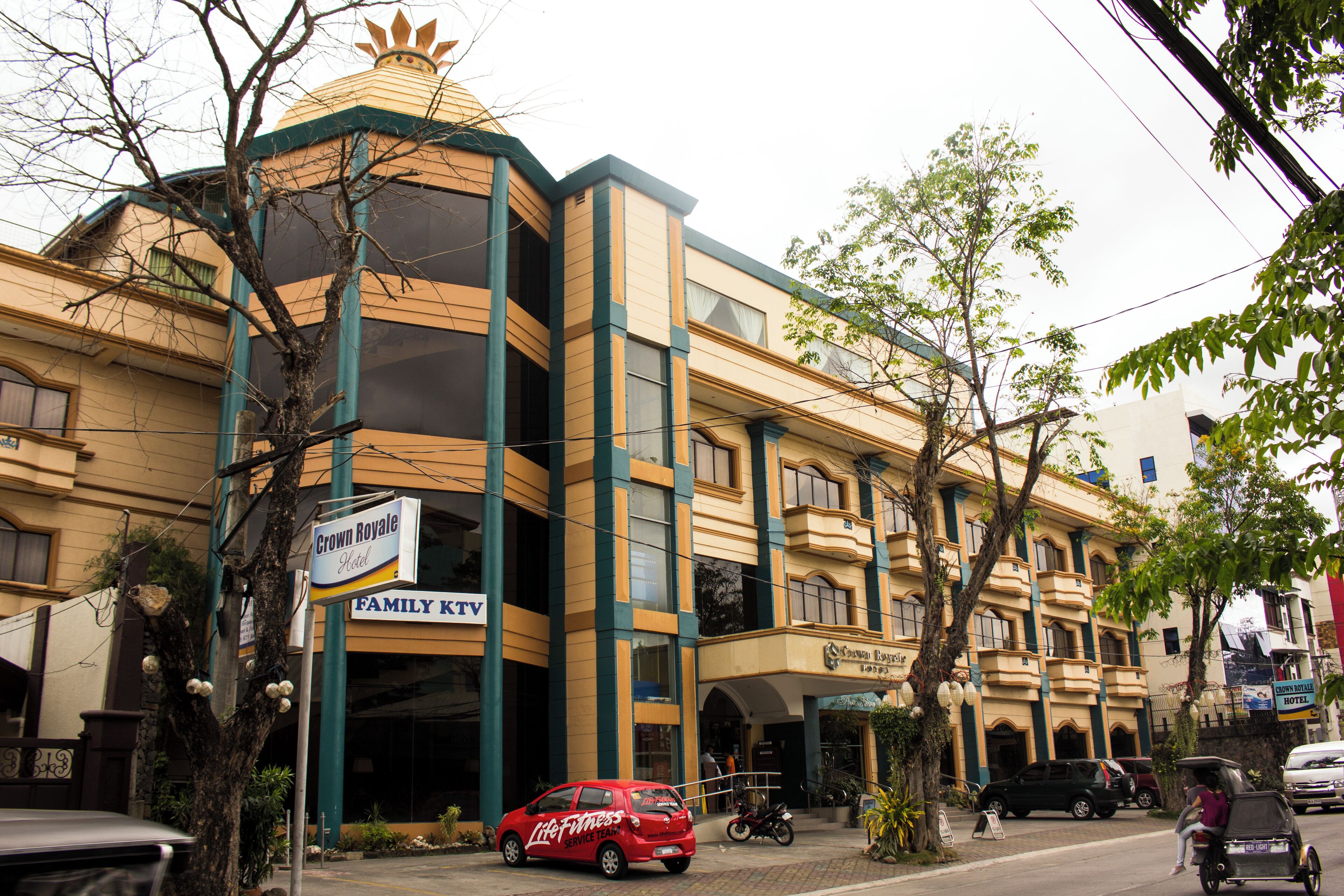 A hotel with a sign for Crown Royale Hotel and Family KTV.