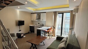A modern apartment with a kitchen, dining area, and living room. - Aldino Residence (Ankara)