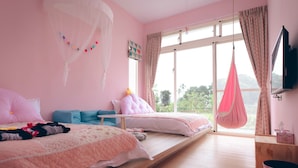 A pink-themed bedroom with two beds, a hanging chair, and a large window with curtains.