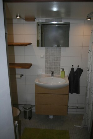 A bathroom with a sink, mirror, and towel rack. - Lilla Huset på slätten B&B (Lund)