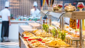 A buffet with various food items and a chef in the background. - Barut B Suites - All Inclusive (Manavgat)