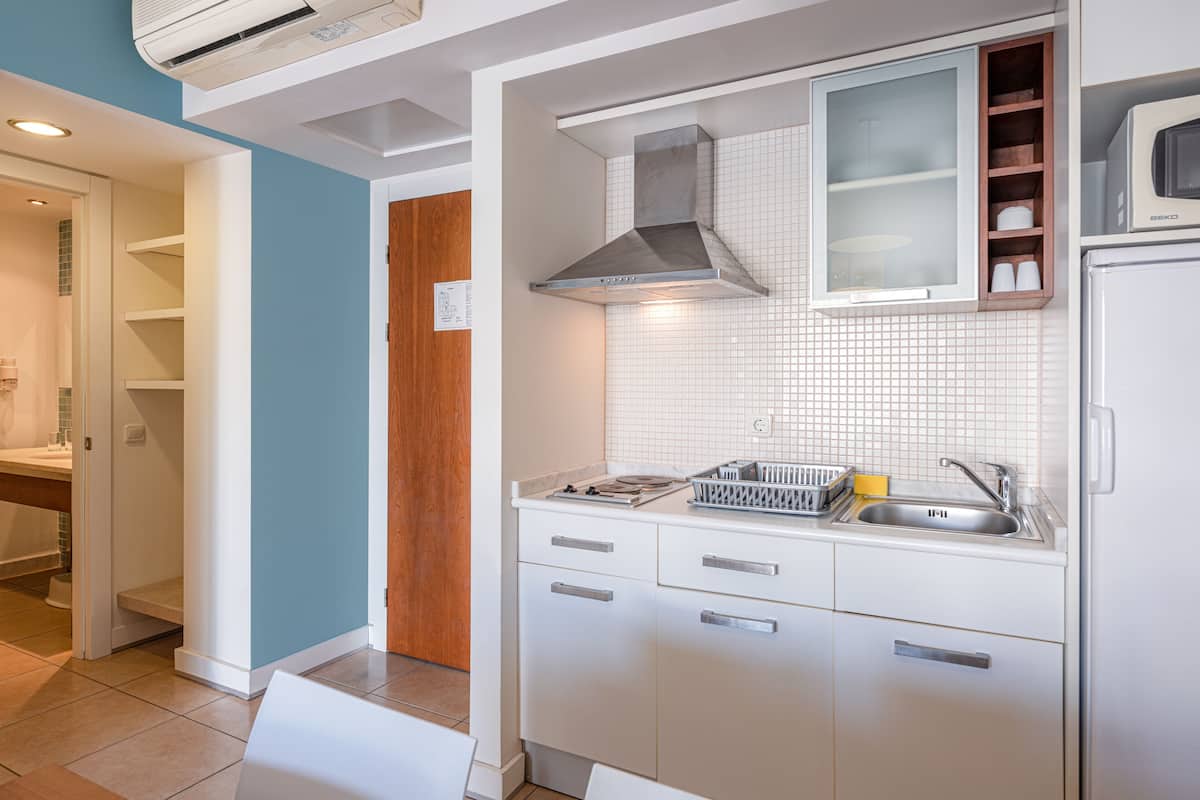 full-sized fridge, microwave, stovetop, coffee/tea maker