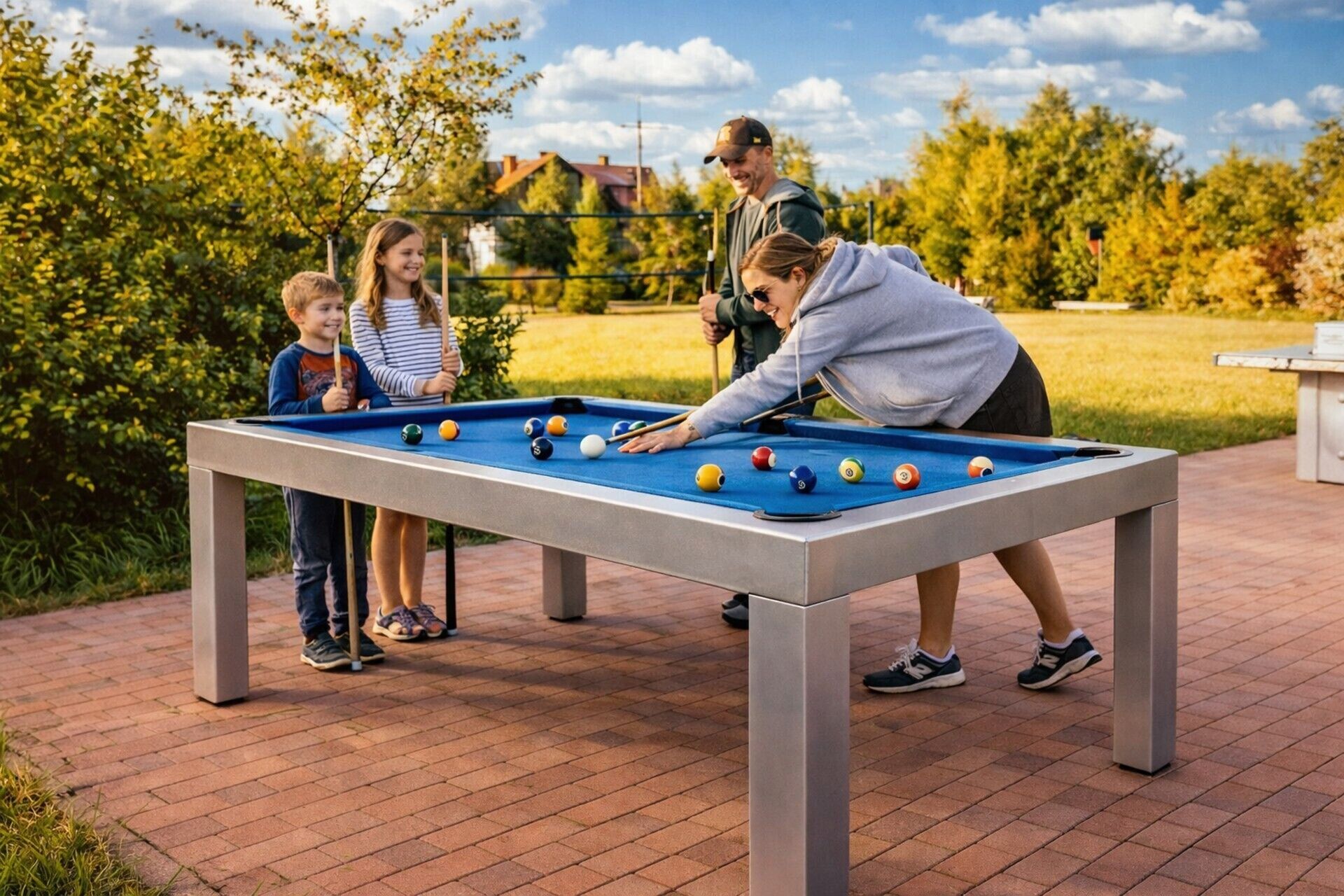A pool table in an outdoor setting with a brick floor and greenery in the background.