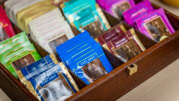 A wooden drawer containing various packets of tea, some labeled with names like Earl Grey.