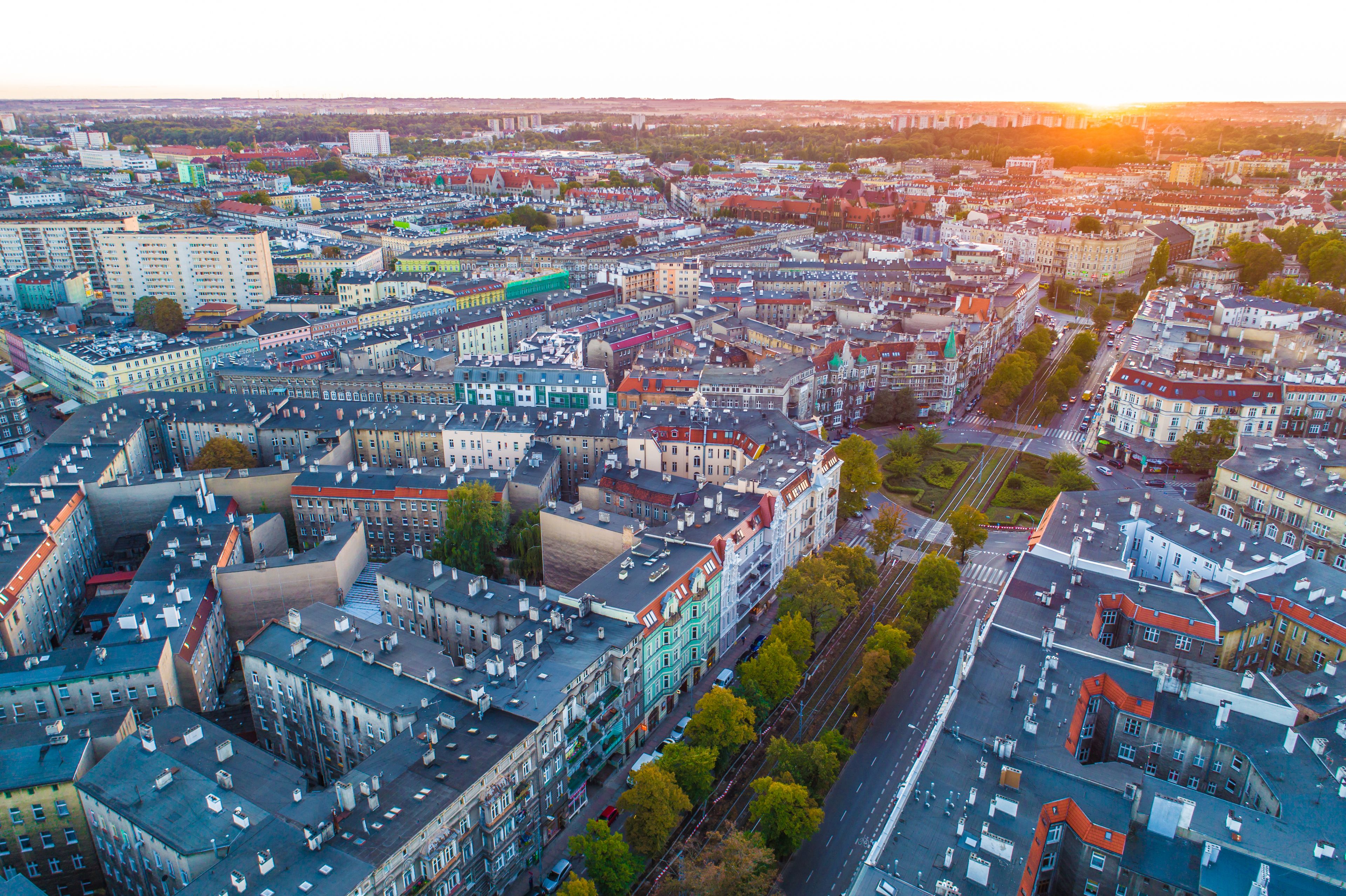 An aerial view of a densely packed urban area with various building styles and a clear road network.