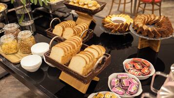 A buffet table with various food items and containers.