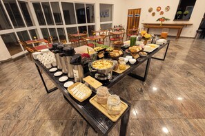 A buffet setup with various food items and beverages.
