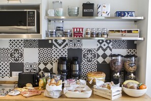 A kitchen with a microwave, toaster, and various food items on the counter. - FeelinRome Bed & Breakfast (Rome)