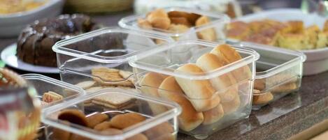 A buffet with various food items in clear containers.